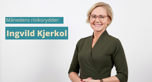 Bilde viser helseminister Ingvild Kjerkol fr hoften og opp. Hun er ikledd en mørk grønn omslagskjole og briller. Hun har hendene foldet foran seg.